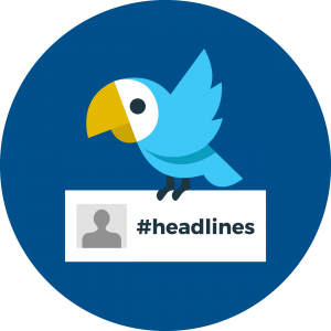 bird holding the hashtag #headlines on a white card
